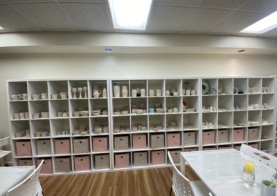 wall with shelves of bisque pottery at TDBA