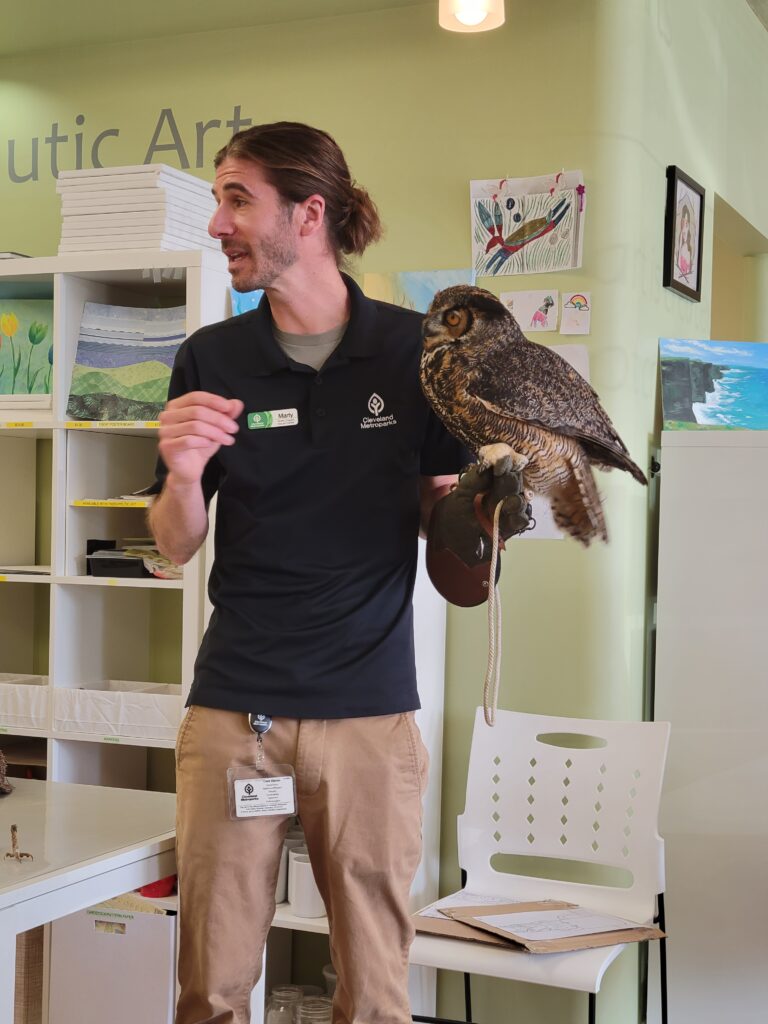 marty calabrese holding an owl inside the studio