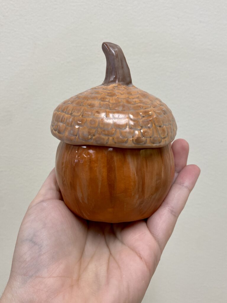 clay jar in the shape of an acorn