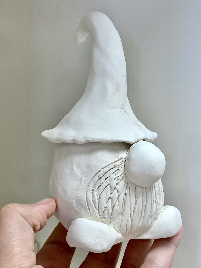 creature with big hat, no eyes, and big noes, and shoes