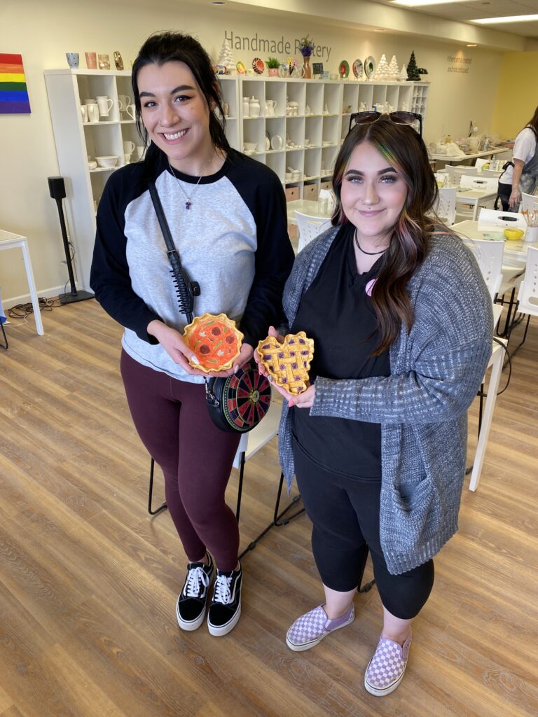 two guests standing with their finished pie plates