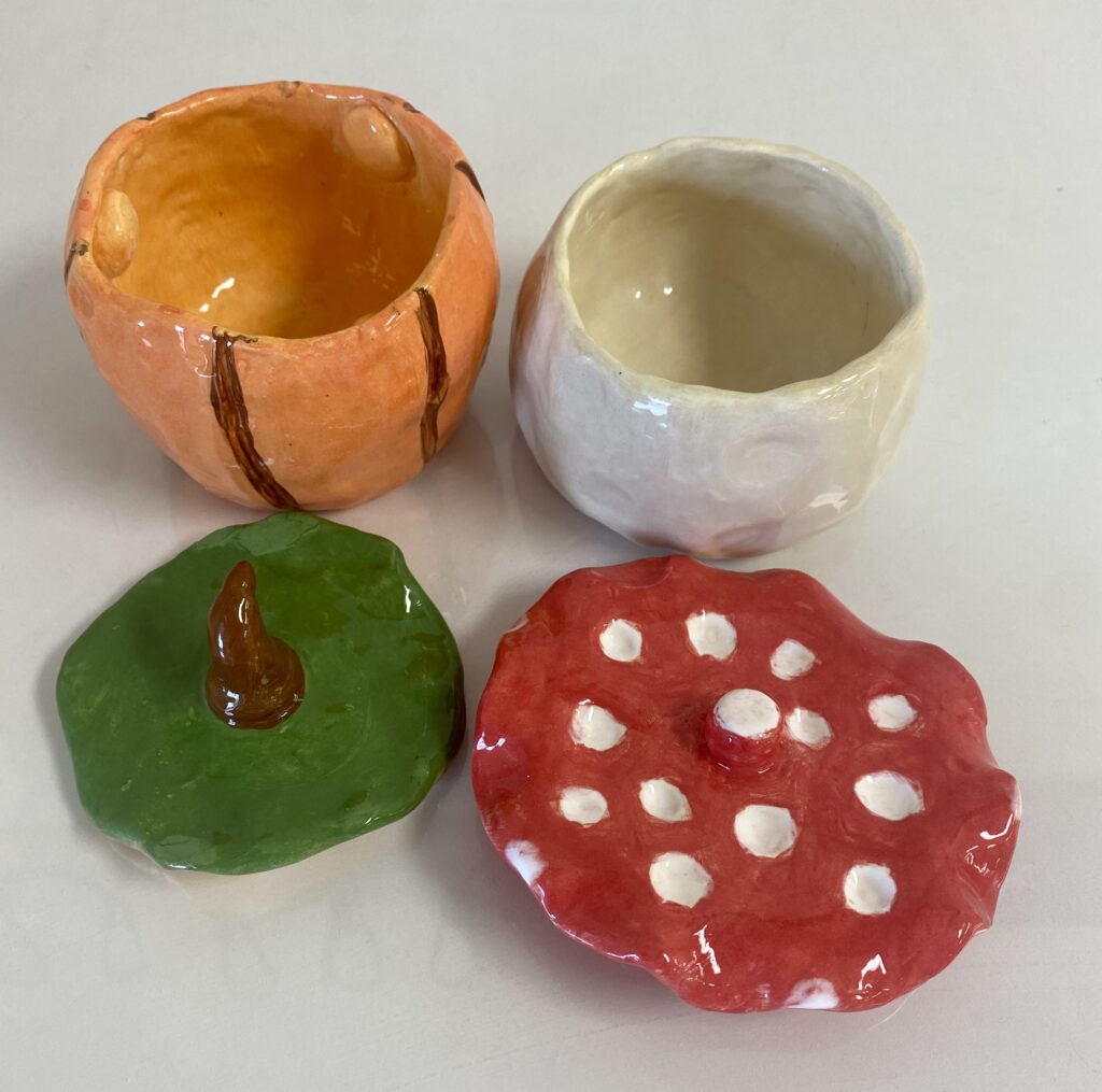 two clay jars with the lids taken off