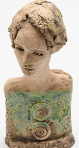 ceramic portrait of a person with swirls on their chest