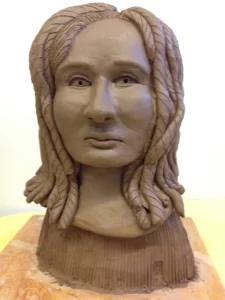 clay portrait bust of a person with long hair